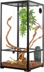 Glass reptile terrarium with ventilation, climbing branches, artificial plant and wood chips substrate
