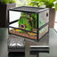 PVC reptile terrarium with front glass doors, realistic plants, and secure mesh top.
