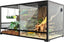 Glass reptile terrarium with branches, plants, background, and dual substrate for lizards.