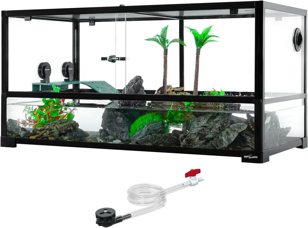 Glass reptile terrarium tank with rocks, fake plants, ramp, and included water hose accessory.