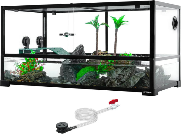 Glass reptile terrarium tank with rocks, fake plants, ramp, and included water hose accessory.