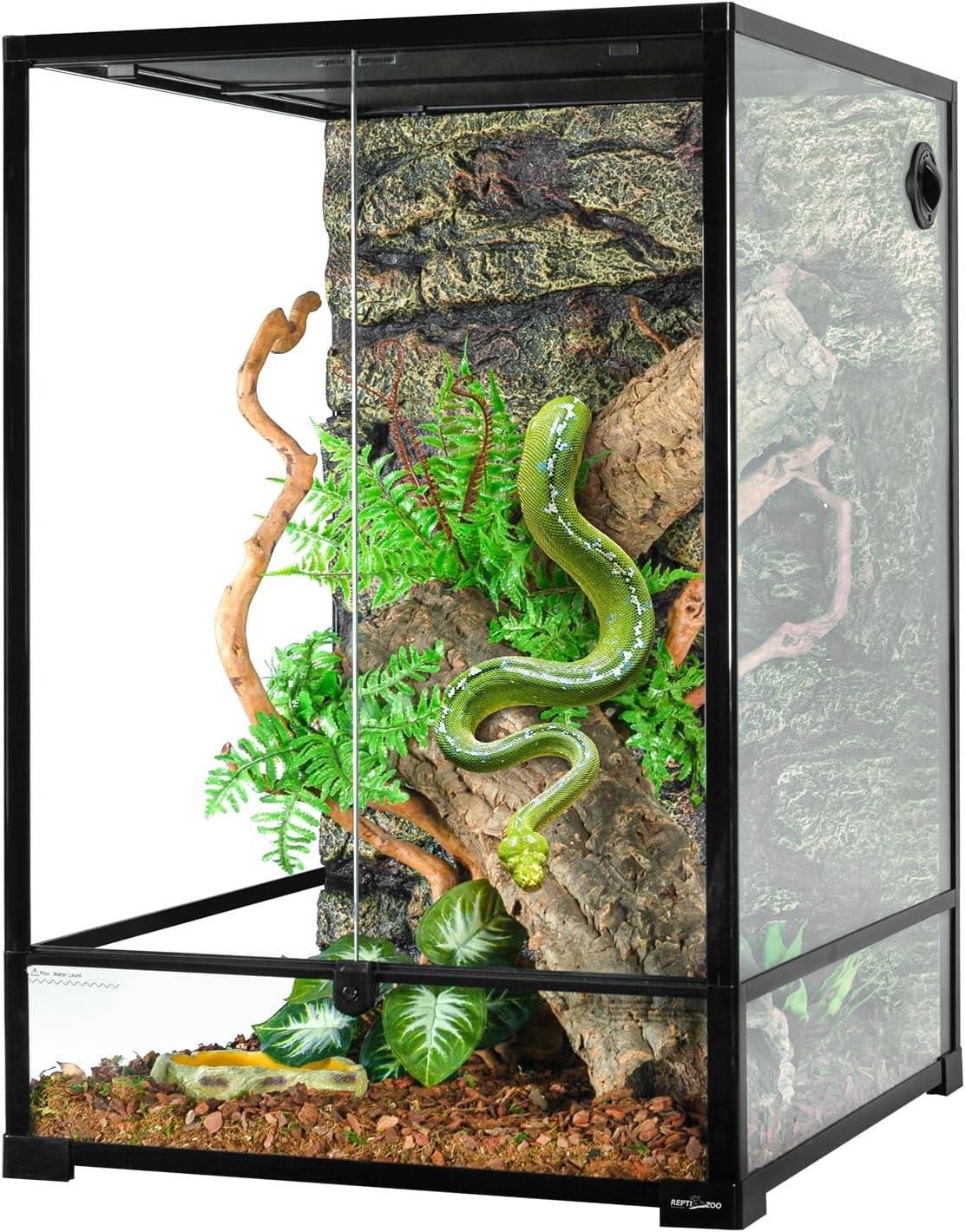 Glass reptile terrarium with green snake, natural branches, and artificial plants inside enclosure