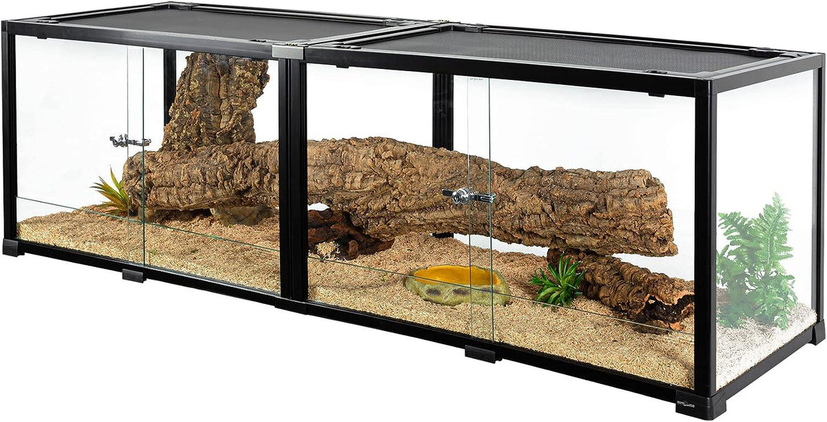 Large glass reptile terrarium with sliding doors, logs, artificial plants, and sand substrate Main image