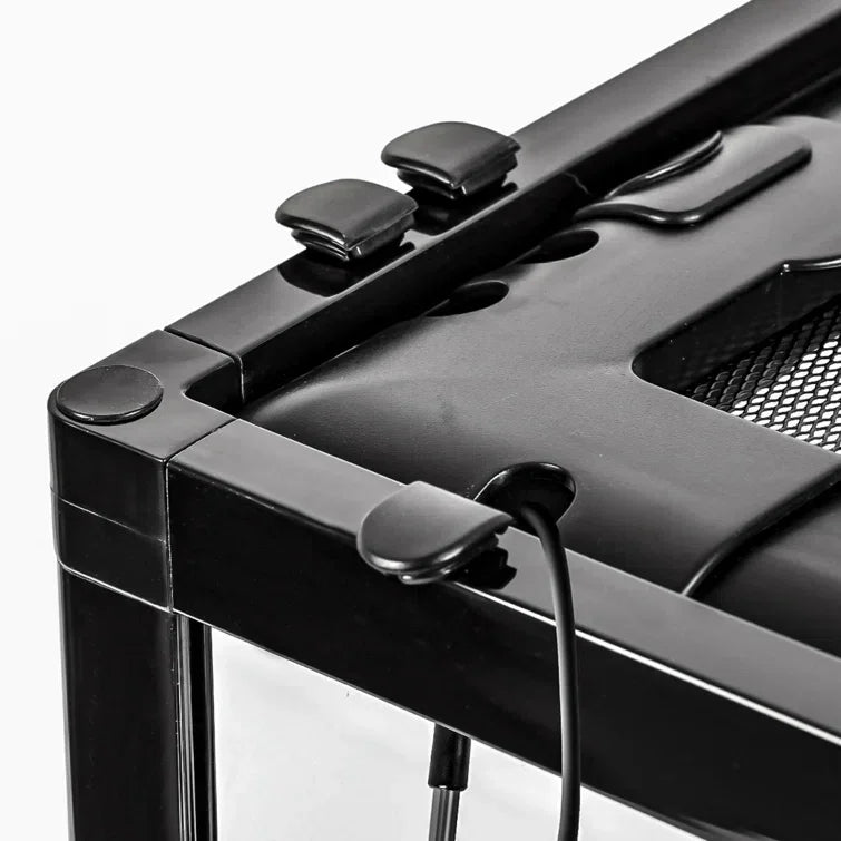 Close-up of black reptile terrarium corner with mesh top and secure cable ports.