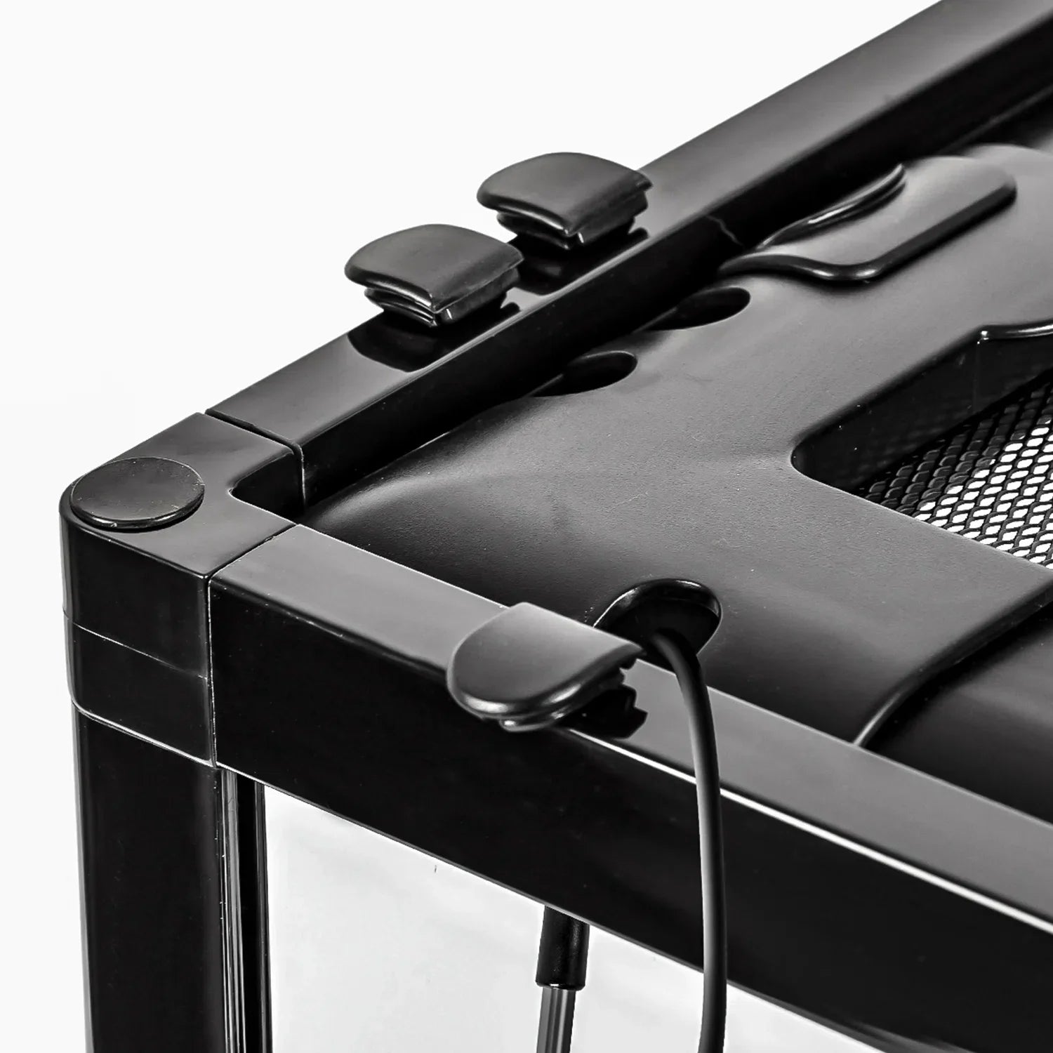 Close-up of reptile terrarium corner with secure locking clips and cable outlet