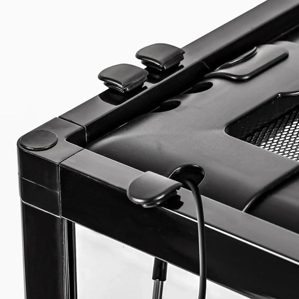 Close-up of reptile terrarium corner with secure locking clips and cable outlet