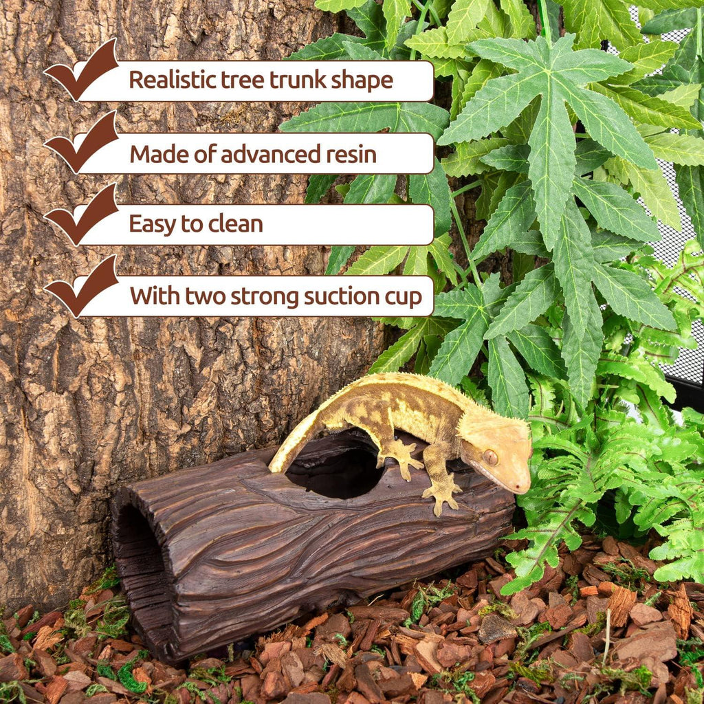 Resin reptile hideout log with gecko on top, surrounded by plants in terrarium setting.