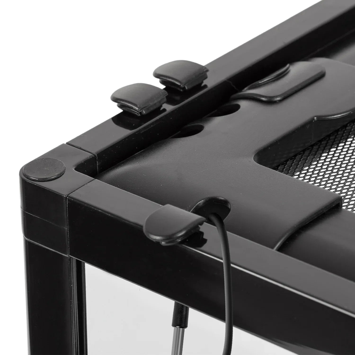 Close-up of black reptile terrarium top corner with mesh lid, cable port, and locking clips