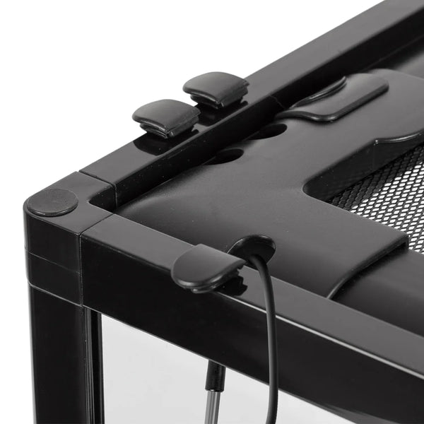 Close-up of black reptile terrarium top corner with mesh lid, cable port, and locking clips