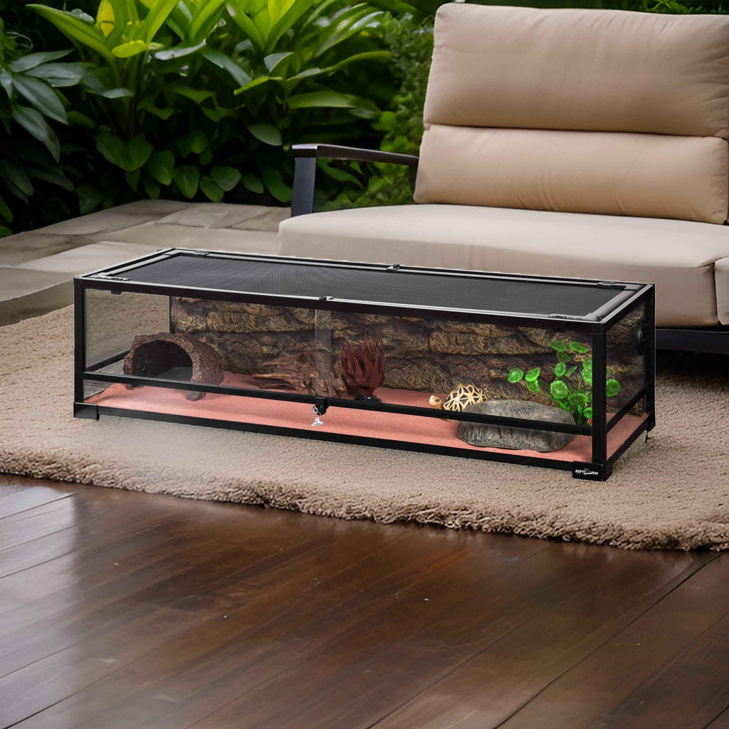 50 gallon glass reptile terrarium with mesh lid and decorative background, indoor setting