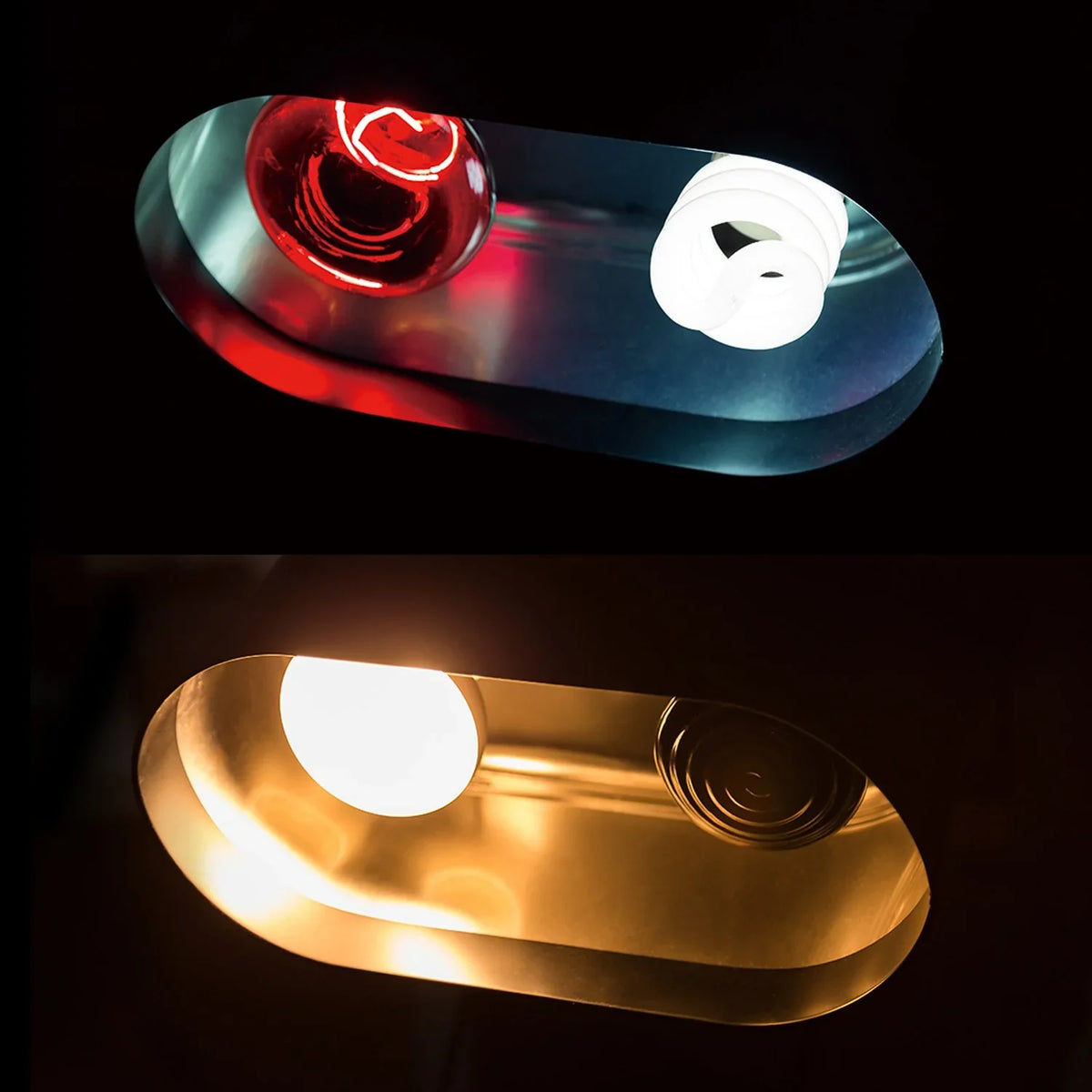 Dual reptile terrarium lamp with red heat bulb and white UVB bulb, illuminated in dark setting