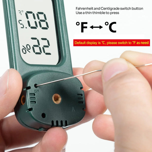 Hand pressing switch on digital reptile thermometer hygrometer to change Celsius Fahrenheit
