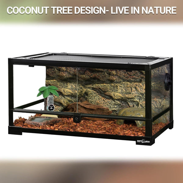 Glass reptile terrarium with coconut tree decoration, digital thermometer, and bark bedding.