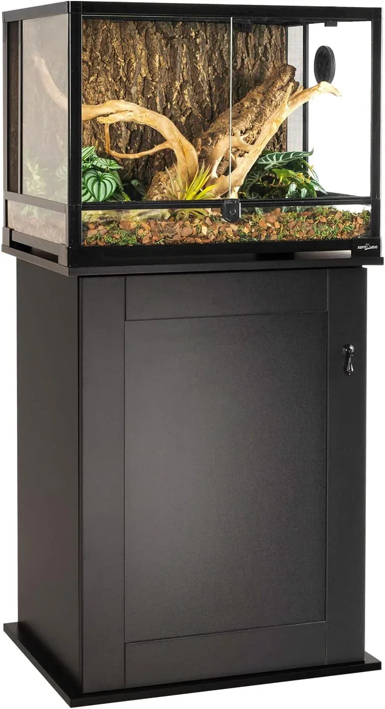 Glass reptile terrarium with front-opening doors, natural decor, and a black storage stand
