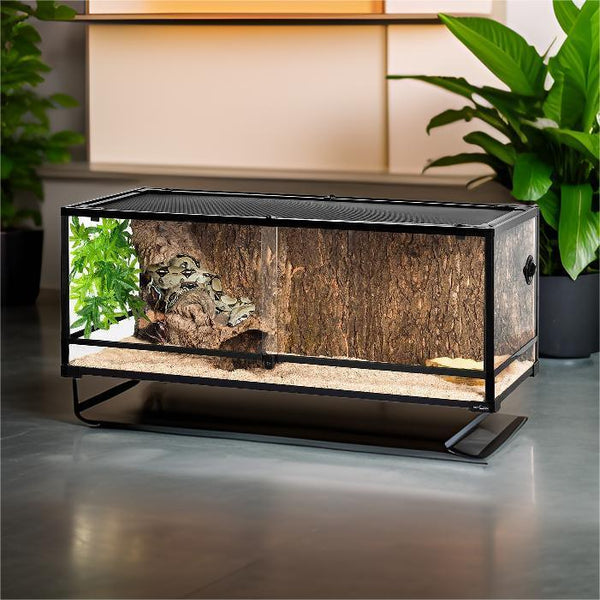 67 gallon glass reptile terrarium with screen top, natural decor, and sand substrate