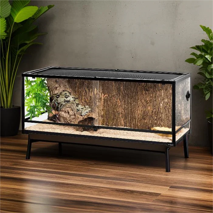 Large glass reptile terrarium with naturalistic background and sand substrate on wood floor Main image