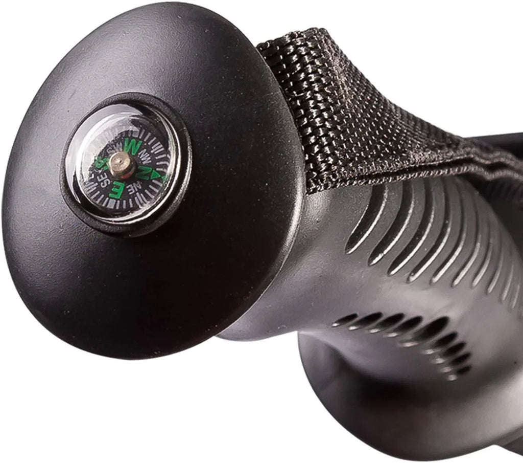 Close-up of a black handle with textured grip, wrist strap, and built-in compass