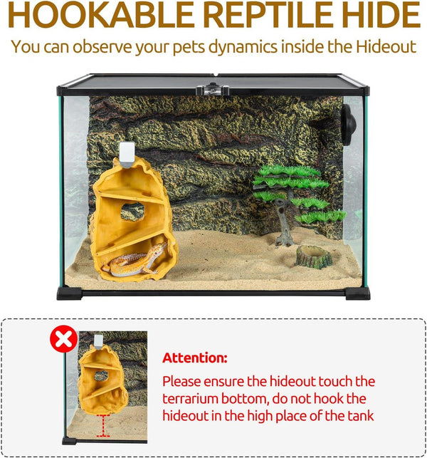 Glass reptile terrarium with hookable hideout, sand substrate, and decorative tree.