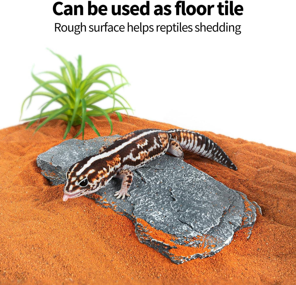 Leopard gecko on textured reptile terrarium floor tile with sand and artificial plant