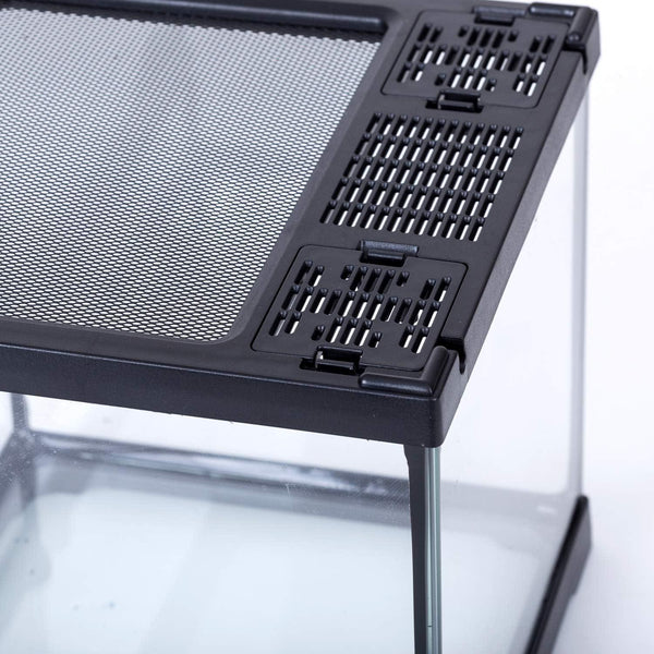 Close-up of reptile terrarium with mesh top and adjustable ventilation panels