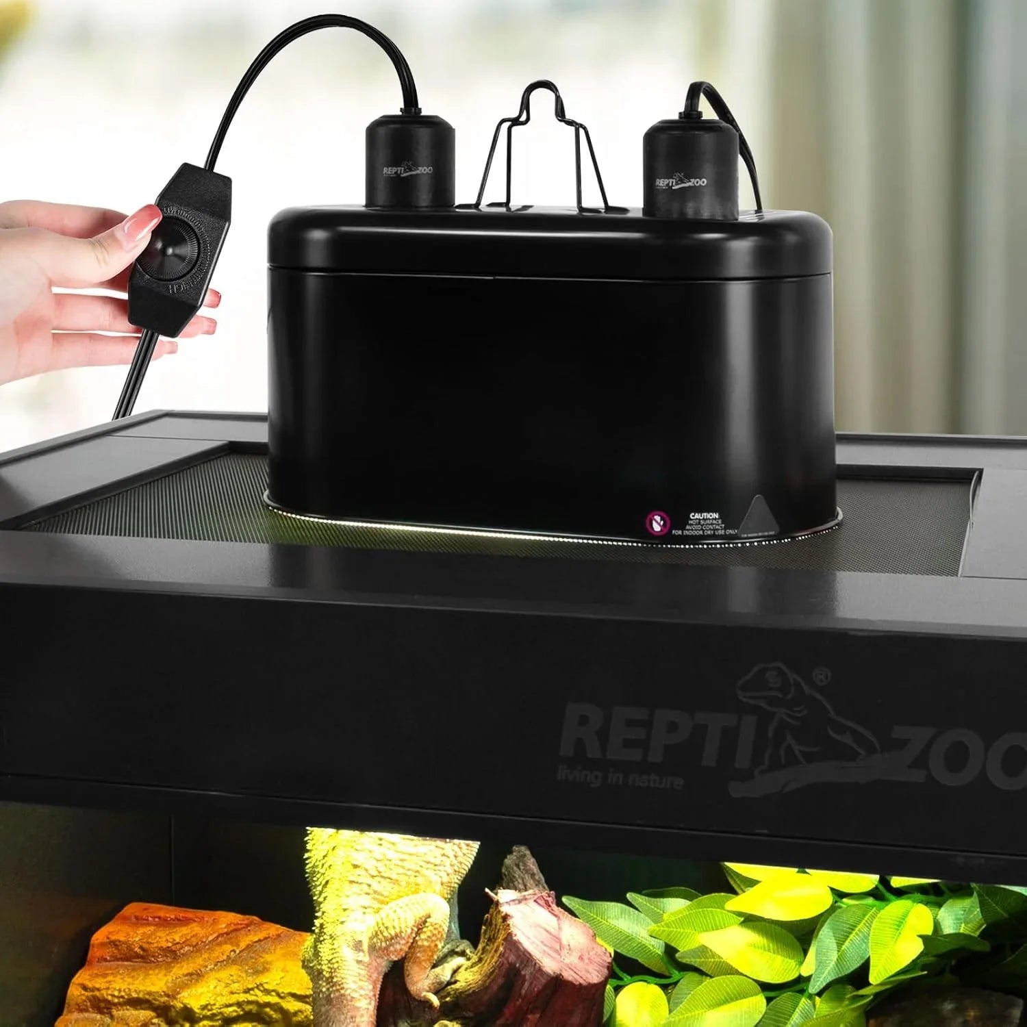 Black reptile terrarium heating and UVB lamp fixture with adjustable switch on enclosure lid