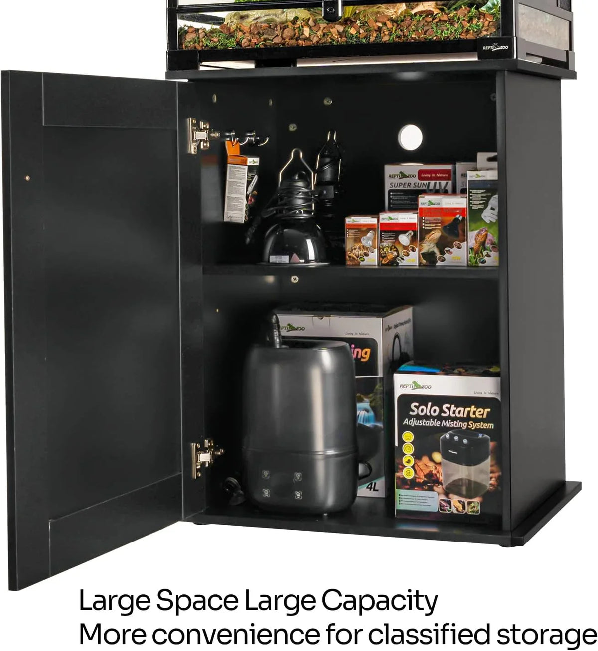 Black reptile terrarium cabinet with open storage showing heating lamps, bulbs, and misting system boxes.