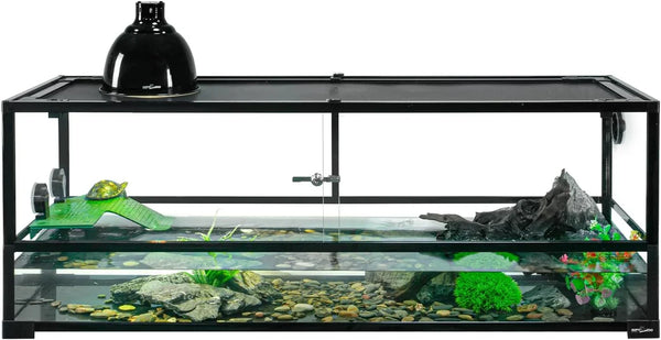 Glass reptile terrarium with UVB heat lamp, turtle basking ramp, rocks, and aquatic plants