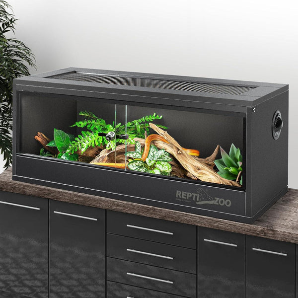 Glass reptile terrarium cage with sliding doors, ventilation, plants, and wood decor
