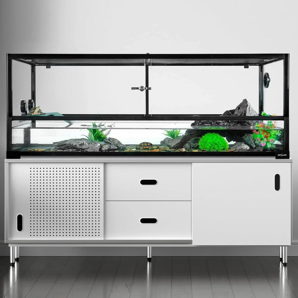 Large glass reptile terrarium with rocks, plants, and water on modern white stand.