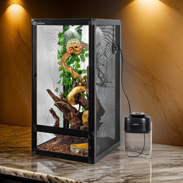 Mesh reptile terrarium with chameleon, misting system, vines and wood branches