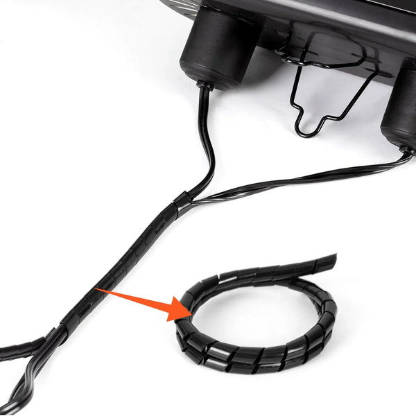 Black wire organizer spiral wrap securing cords for reptile terrarium heat lamp setup