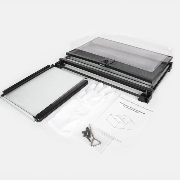 Knockdown glass reptile terrarium kit with mesh lid, gloves, screws, and instruction manual.