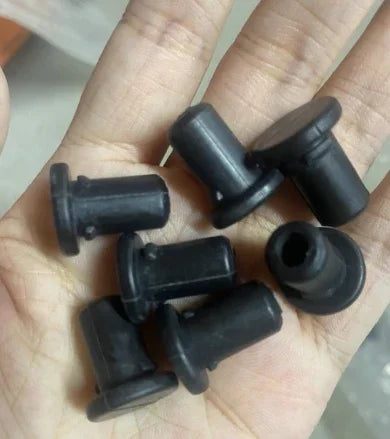Black rubber grommets for reptile terrarium or custom cage, displayed on a hand Main image