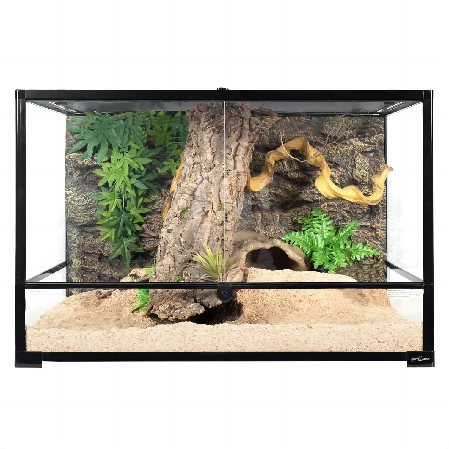 Glass reptile terrarium with naturalistic background, driftwood, plants, and sandy substrate.